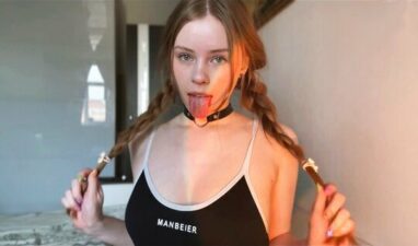 A young girl with pigtails gently sucks her boyfriend’s dick