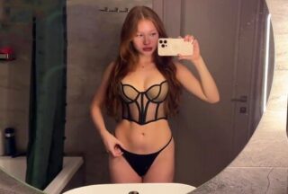 A red-haired minx in lingerie perfectly sucks the trunk of her chosen one